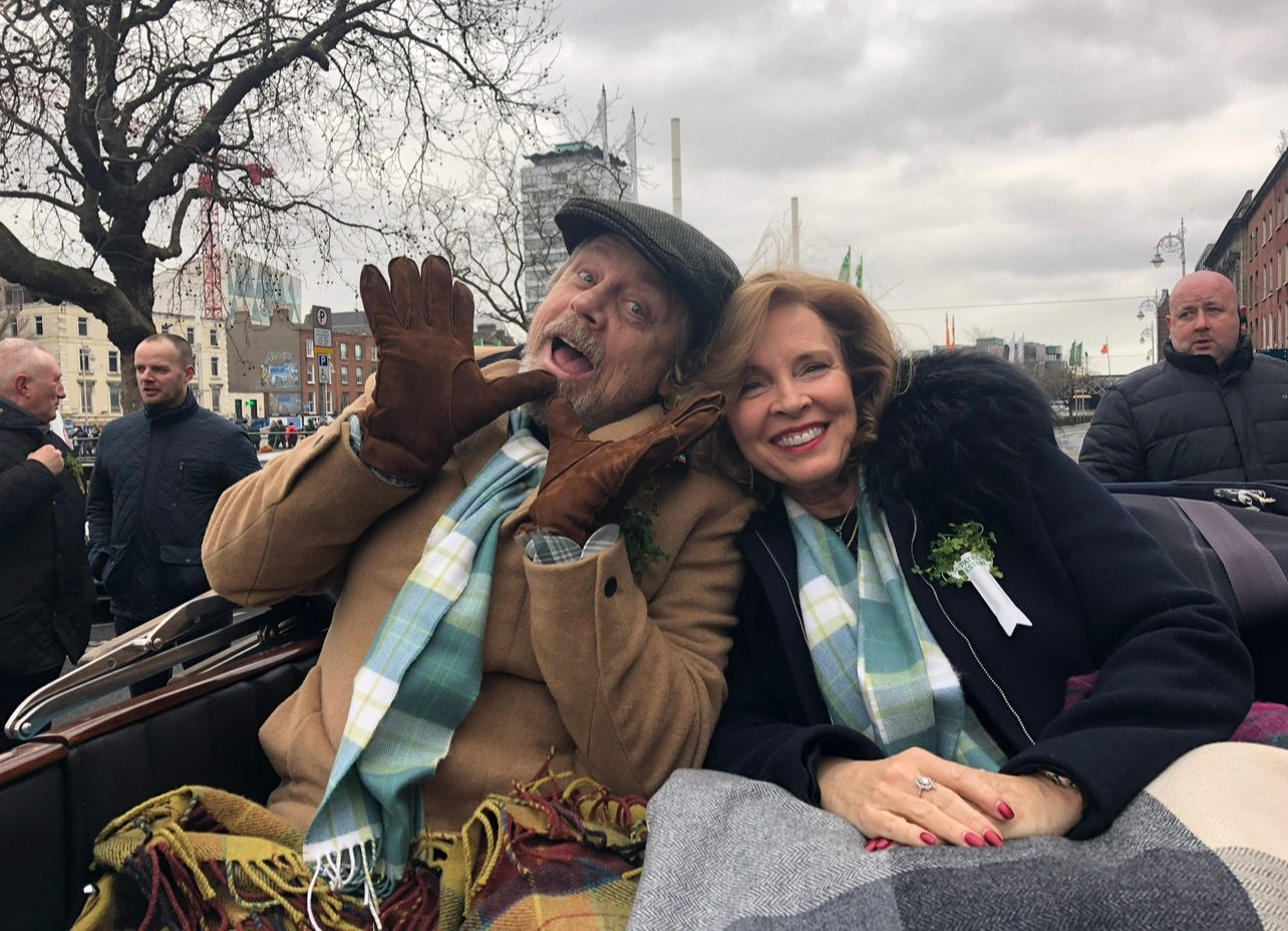 Mark Hamill waving from a crowd on a winter day